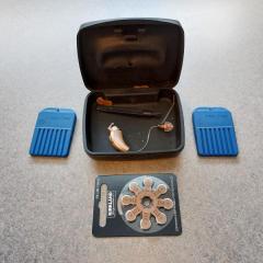Hearing Aid: Case, Batteries, Tools & Hearing Aid found in an employee locker in the Health Center.