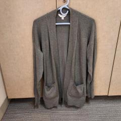 Women's dark grey cardigan sweater found in an employee locker in the Health Center.