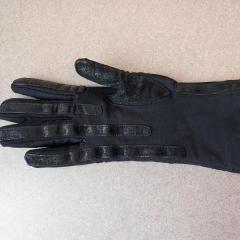 Women's black glove left on Manor Reception's desk.