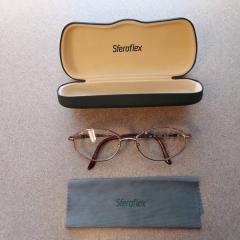 Black Sferoflex glass case with cleaning cloth and rose gold rimmed glasses found in the entrance of the Manor.