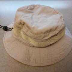 Khaki bucket style hat by Stetson found in the Manor vestibule.