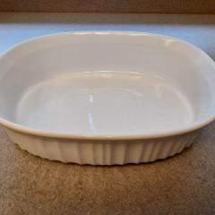 French White oval dish by CorningWare found in the Manor Library.