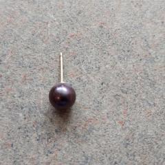 Dark purple ball stud earring found in the Blue Heron Auditorium.