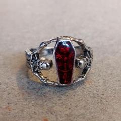 Silver ring with red stone.