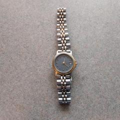 Womens gold and silver metal watch with blue face found at the Health Center.