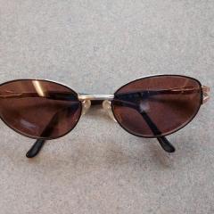 Gold rimmed prescription sunglasses found in the gravel parking lot across from The Neighborhoods.