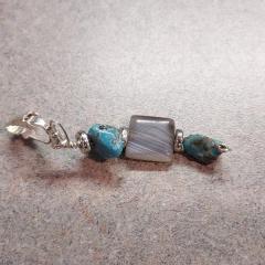 Silver clip on earring with 3 stones (2 turquoise and 1 grey square) found on the Court gravel lot.