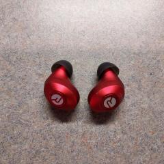 Pair of red and black ear buds found on the sidewalk near the putting green.