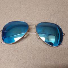 Men's aviator sunglasses with blue lenses found in the game room.