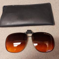 Sunglass attachment and case found at the pond.
