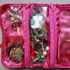 Pink Mary Kay jewelry bag with jewelry.