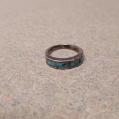 Silver band with turquoise inlay found near the elevator by the garage.