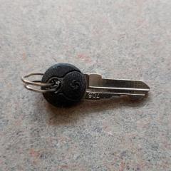 Very small Samsonite key found outside the Manor entrance.