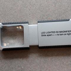 Rectangle, lighted magnifying glass left in one of the shuttle busses. 