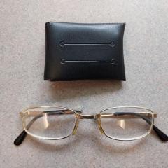Foldable gold rimmed reading glasses.