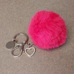 Fluffy pink ball keychain with silver charms found in front of the Terrace.