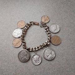 Silver US coin bracelet found in the parking lot by vendor spaces.