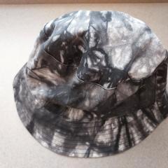 Black and white tye dye bucket hat found in the women's Riverview restroom.