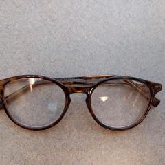 Round lt/dk brown reading glasses found in the Manor A-wing elevator.